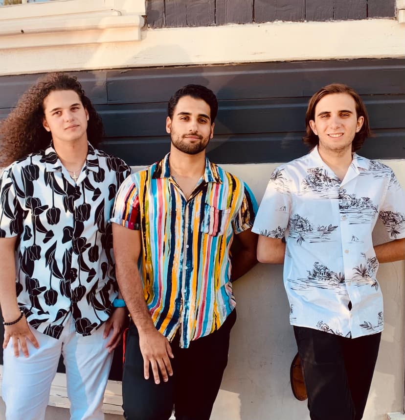 trio in front of a wall